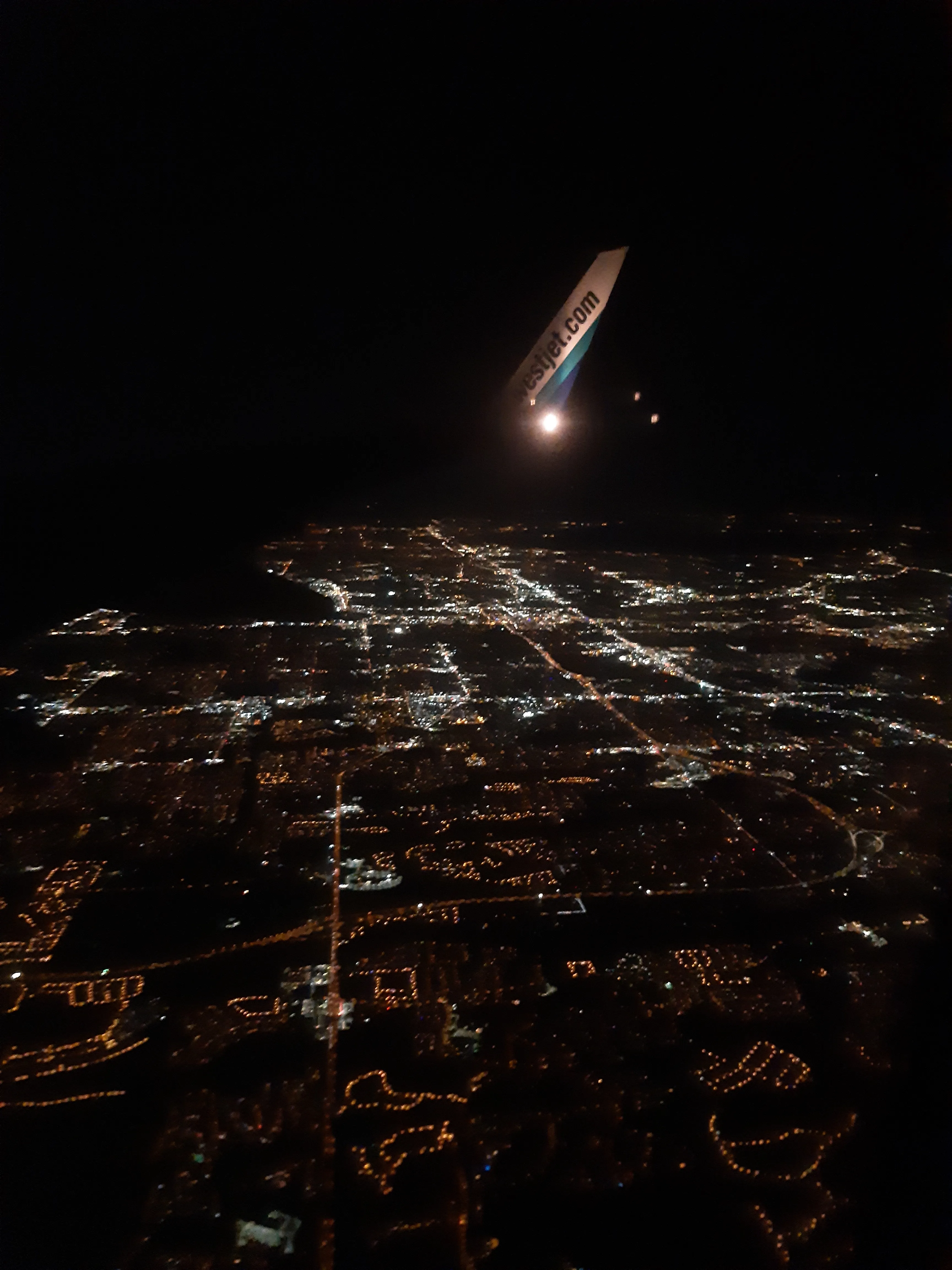 Photo at night taken in a plane over a city