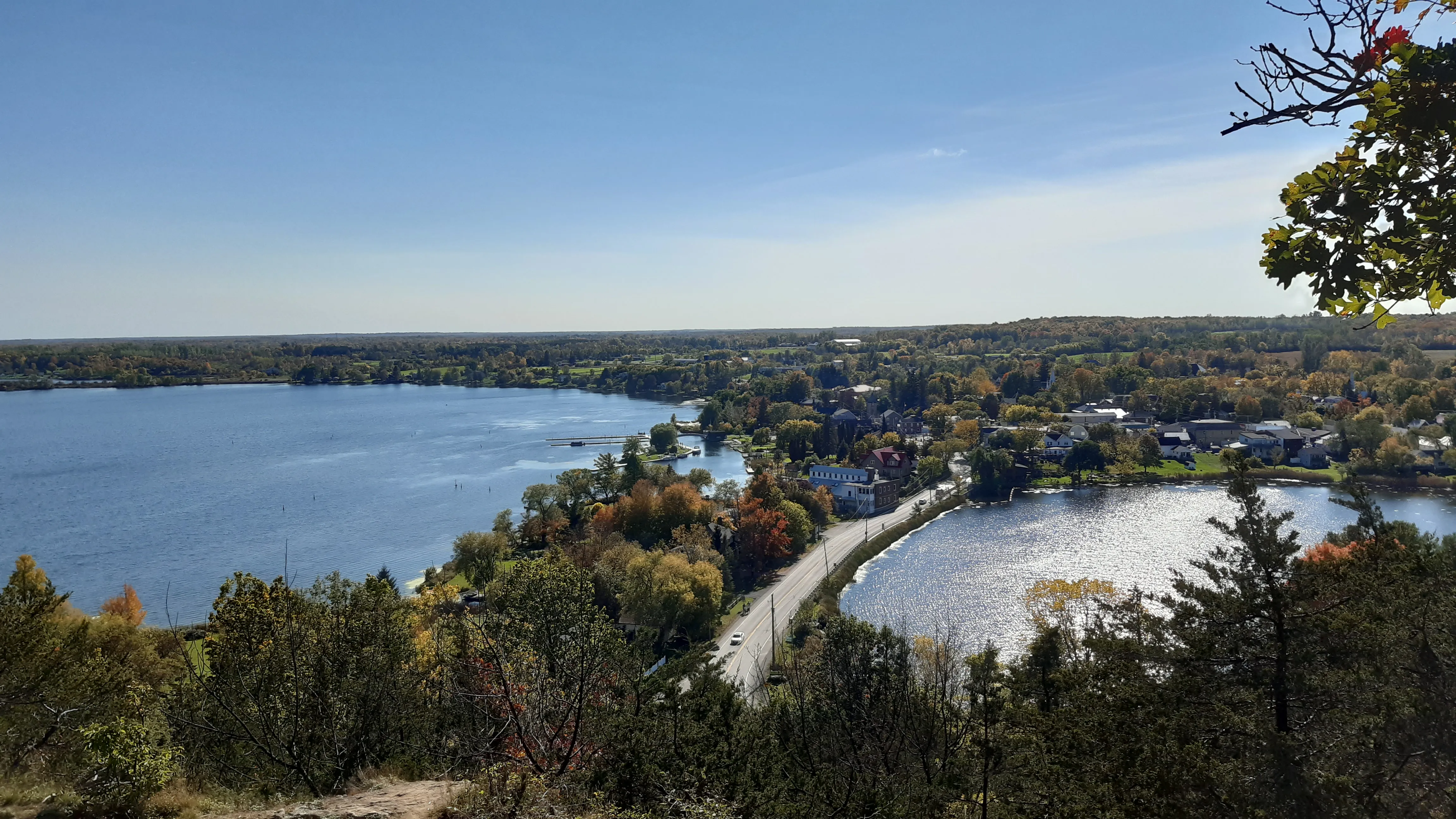Landscape photo of Westport, ON with a road crossing a river