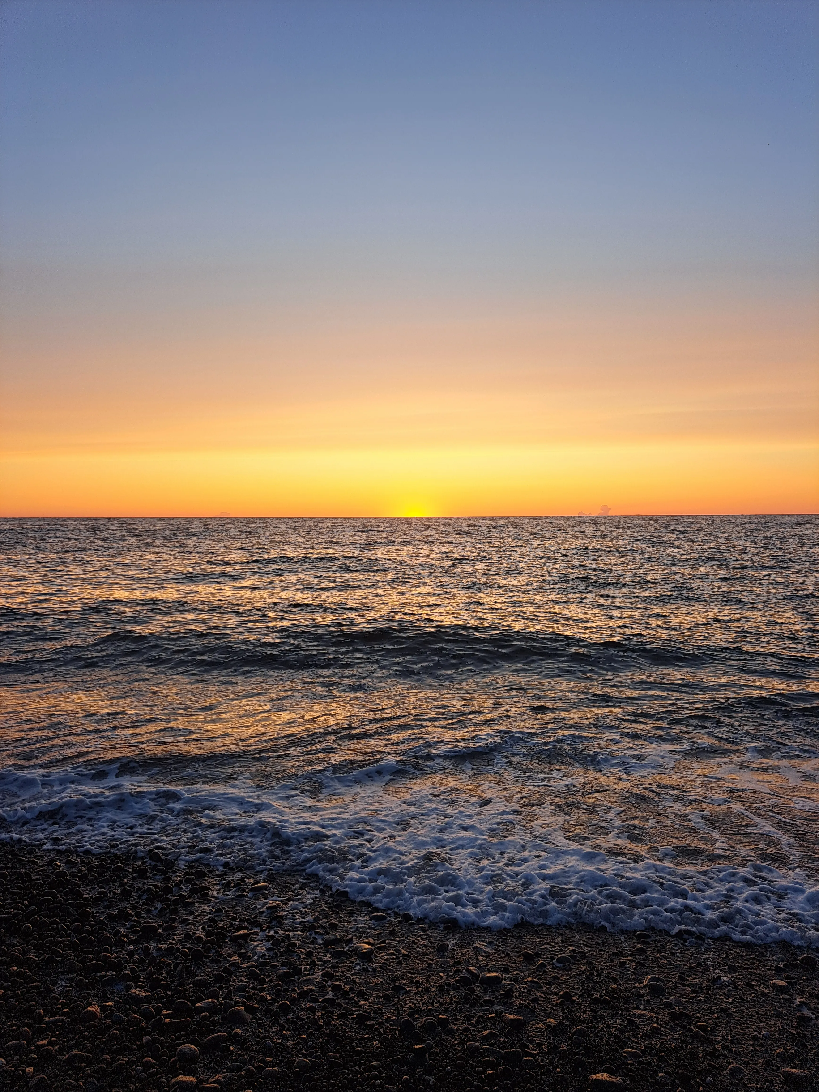 Blue and orange sunset above ocean