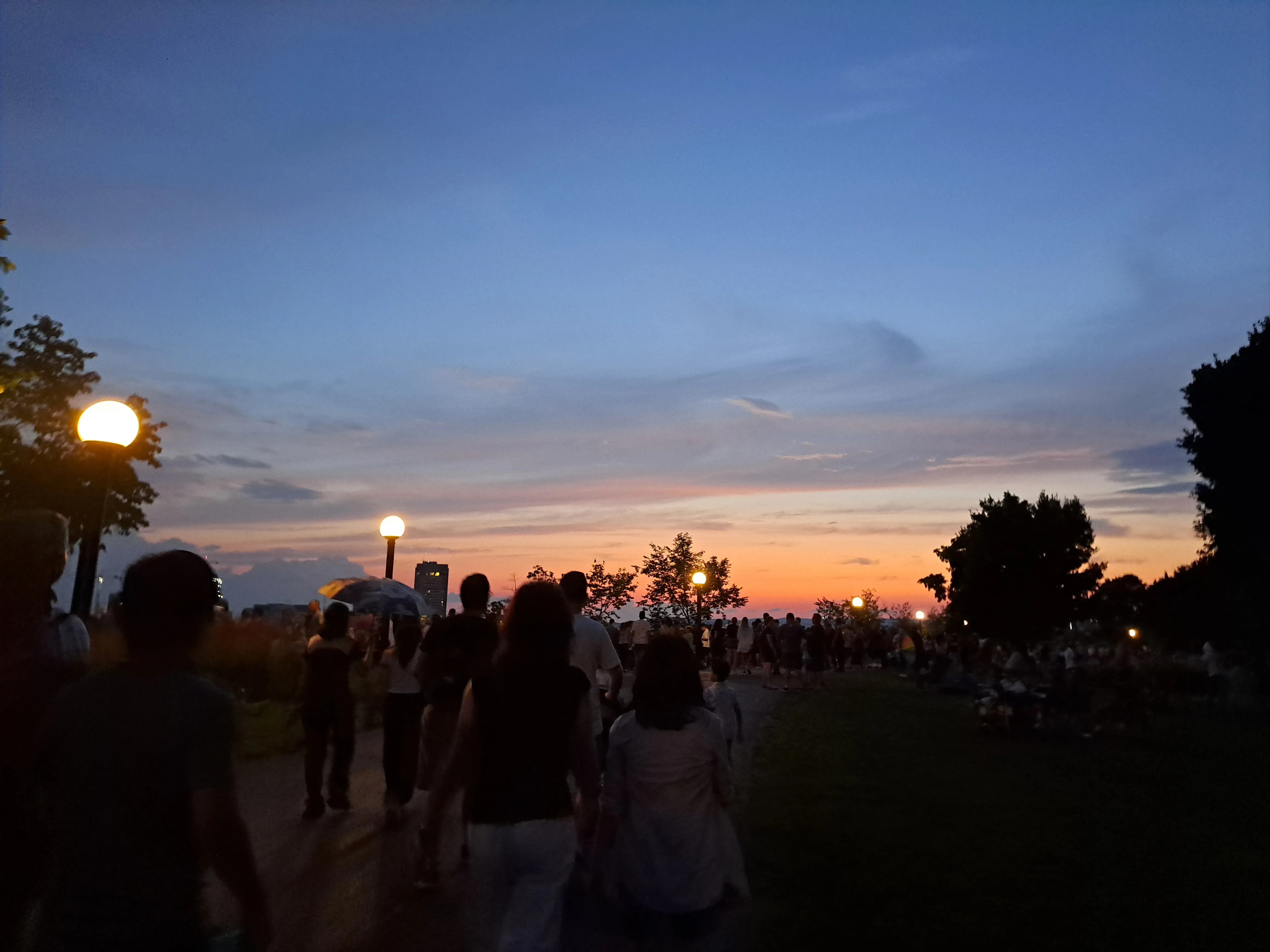 Blue and orange sunset above crowd