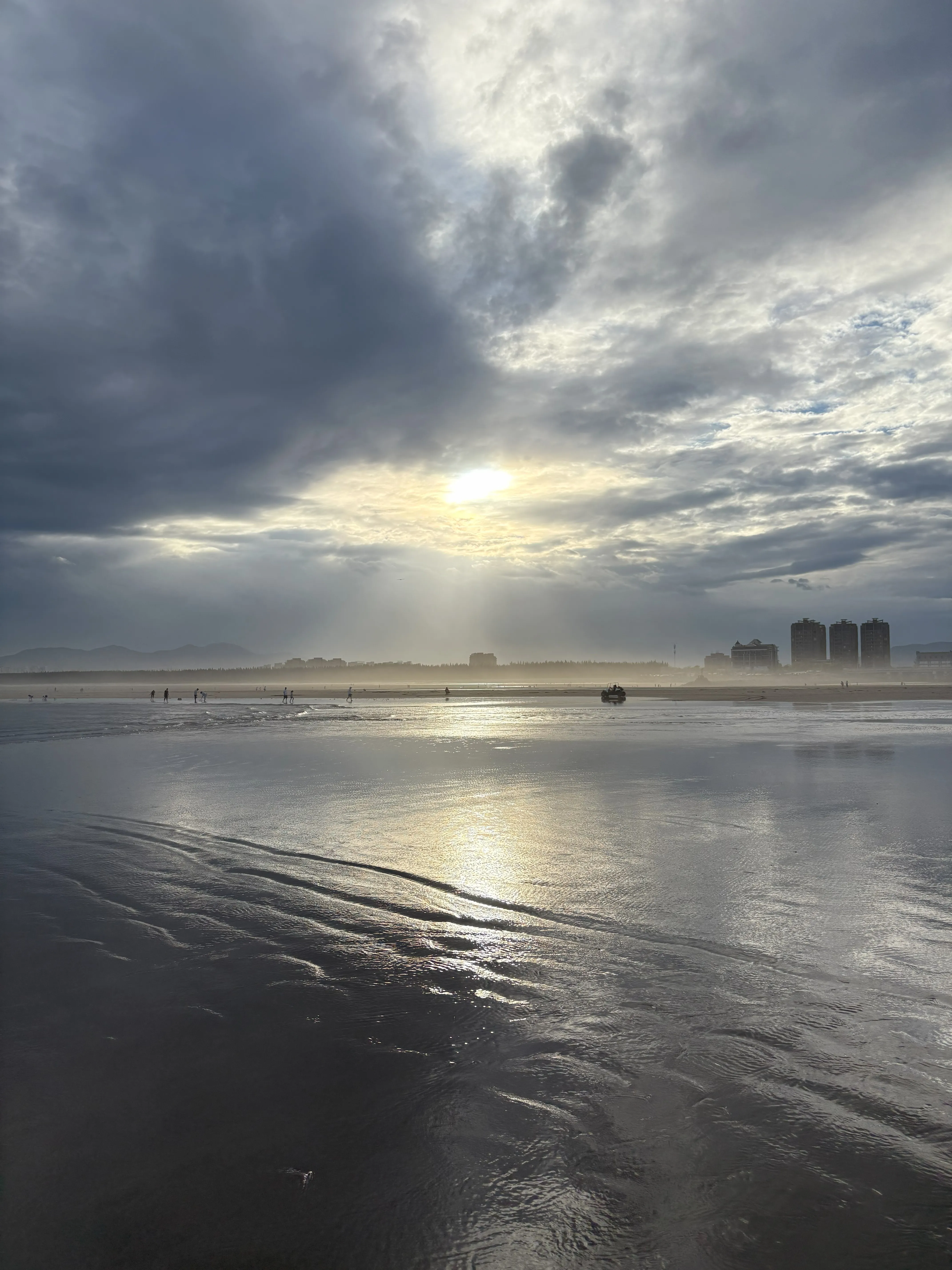 Sun shining through clouds on beach